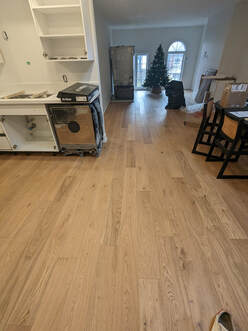 Kitchen and living room with newly installed hardwood floors