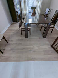 Room with engineered hardwood flooring.
